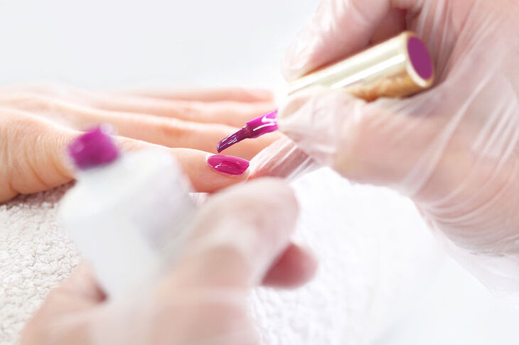 Kosmetyczka maluje paznokcie lakierem hybrydowym