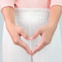 Kobieta składa dłonie w kształt serca