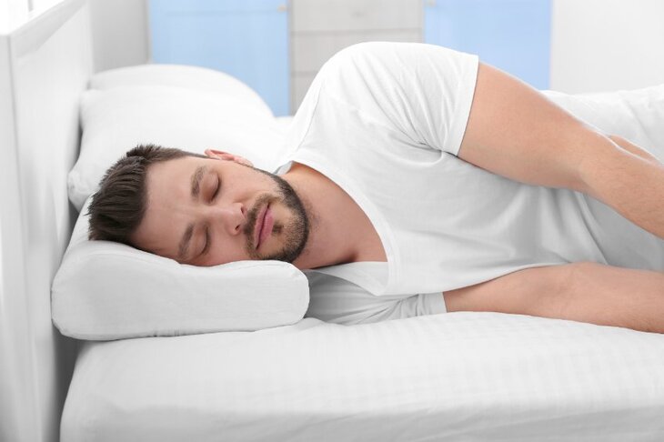 Mężczyzna śpi na specjalnej poduszce