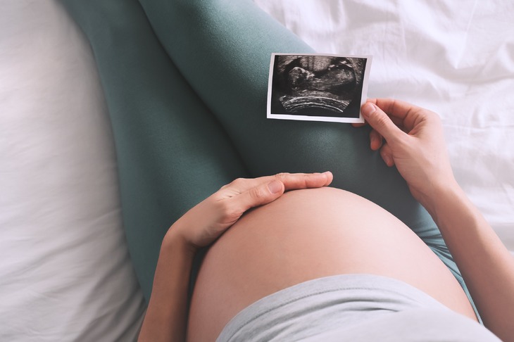 Kobieta w  ciąży patrząca na usg dziecka