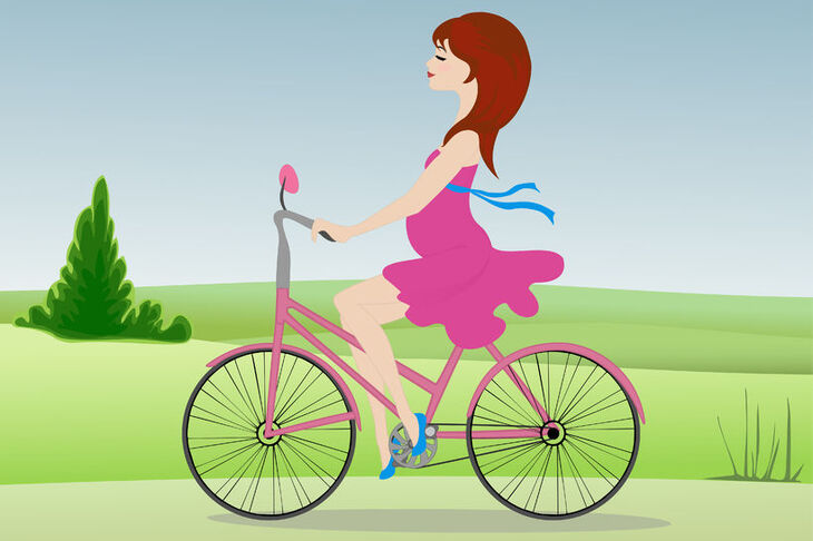 Kobieta w ciąży jadąca na rowerze